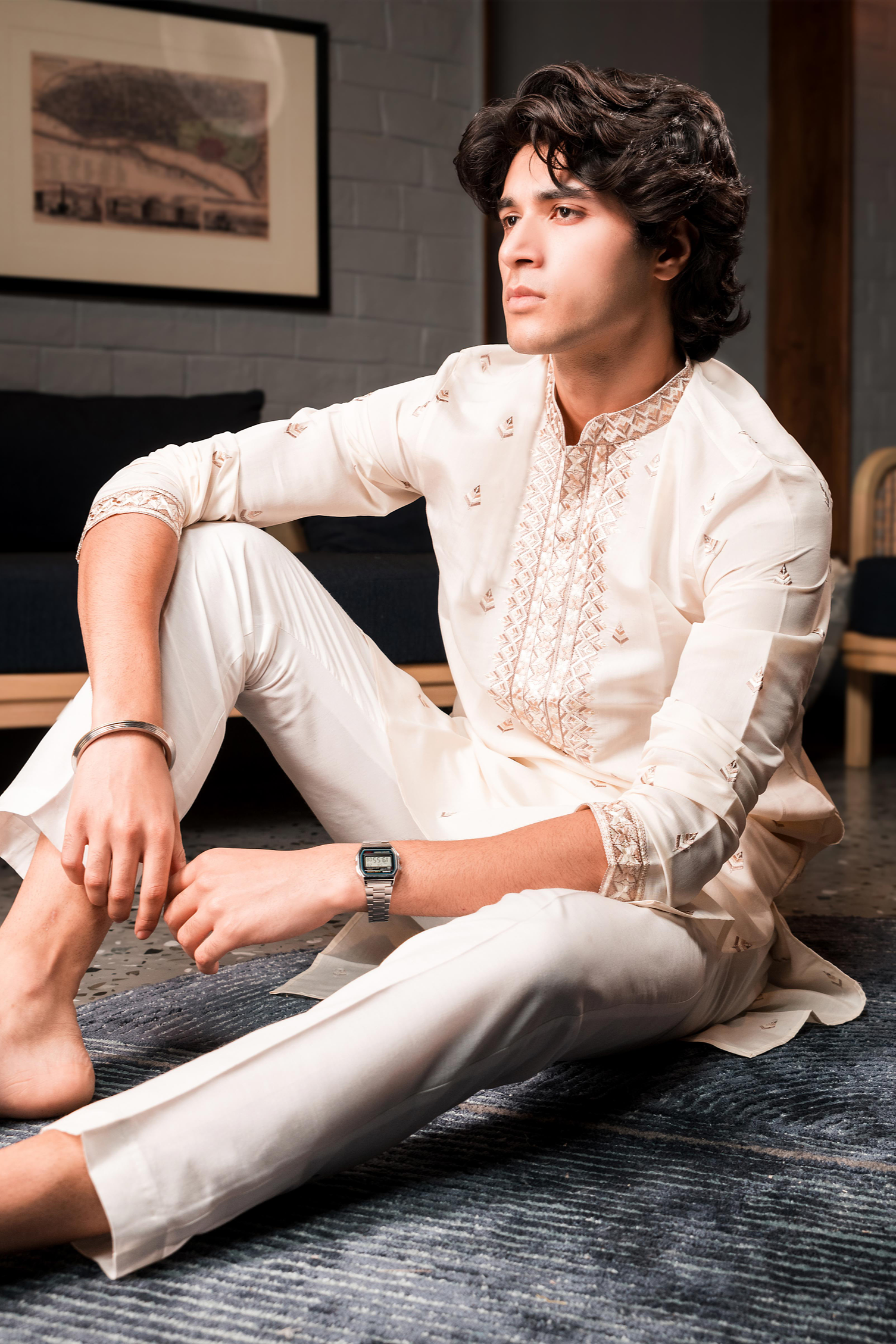 Cream silk kurta with embroidered golden motifs.