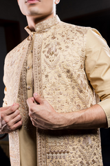 Gold long kurta jacket pant set.